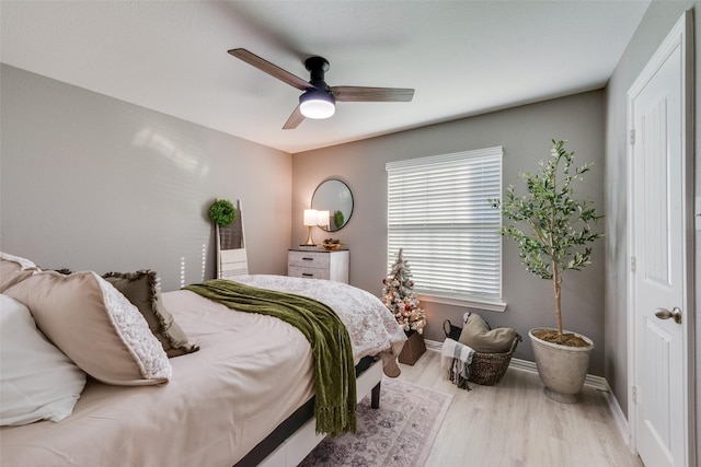 bedroom with ceiling fan and light hardwood / wood-style flooring