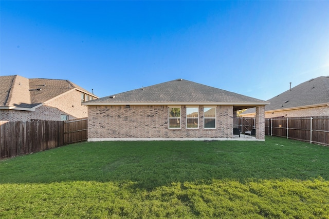 back of property with a patio area and a lawn