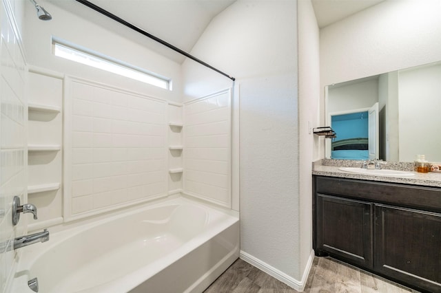 bathroom featuring vanity, hardwood / wood-style floors, and tub / shower combination