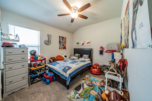 carpeted bedroom with ceiling fan and vaulted ceiling