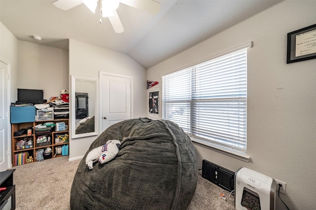 bedroom featuring ceiling fan, vaulted ceiling, and carpet floors