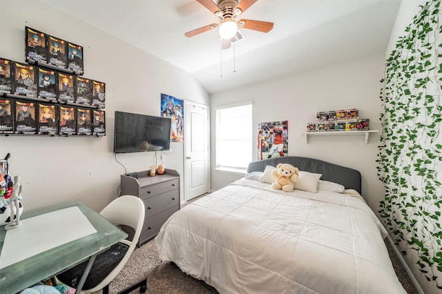 carpeted bedroom with ceiling fan and vaulted ceiling