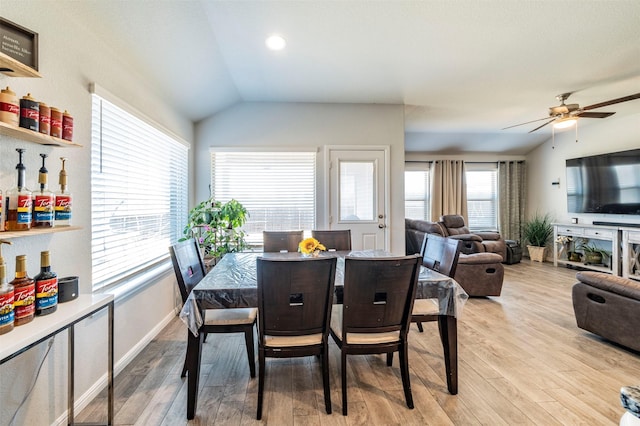 dining area featuring lofted ceiling, ceiling fan, and light hardwood / wood-style floors