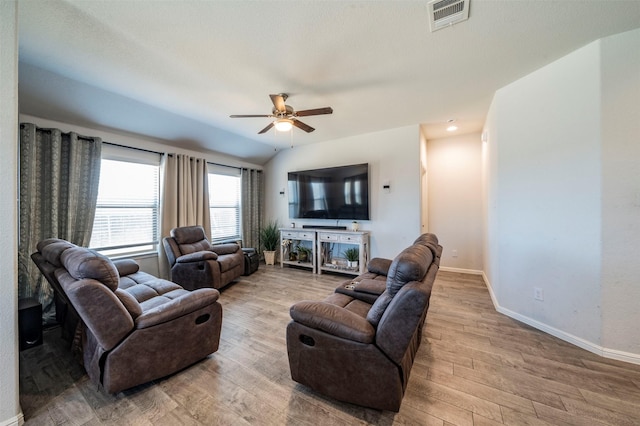 living room with ceiling fan, light wood-type flooring, and lofted ceiling