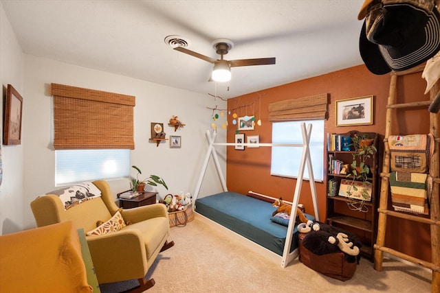 interior space featuring ceiling fan, a wealth of natural light, and carpet flooring