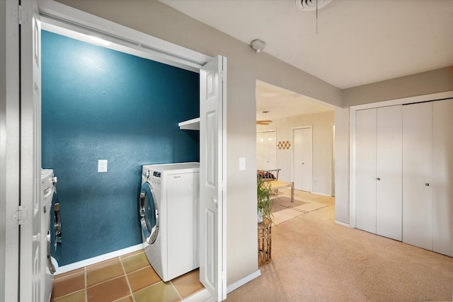 washroom featuring light colored carpet and washing machine and clothes dryer