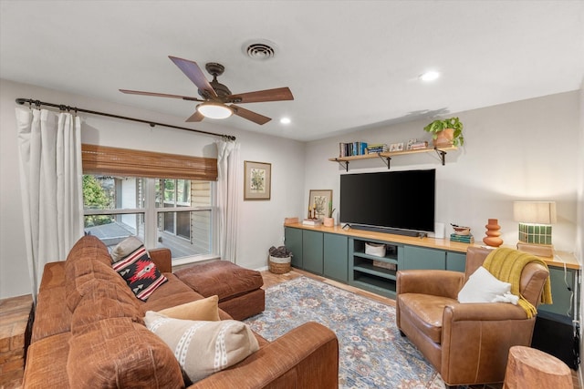 living room featuring ceiling fan and hardwood / wood-style floors