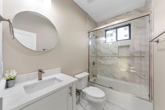 full bathroom featuring toilet, enclosed tub / shower combo, and vanity