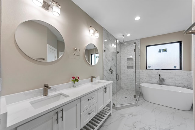 bathroom with shower with separate bathtub and vanity