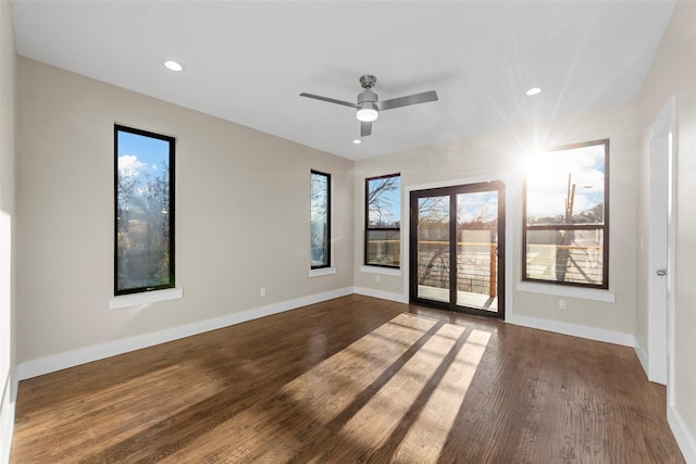 empty room with ceiling fan and dark hardwood / wood-style floors