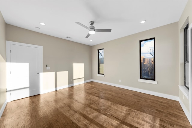 unfurnished room with ceiling fan and hardwood / wood-style flooring