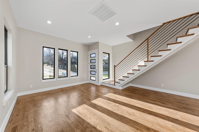 unfurnished living room featuring hardwood / wood-style flooring