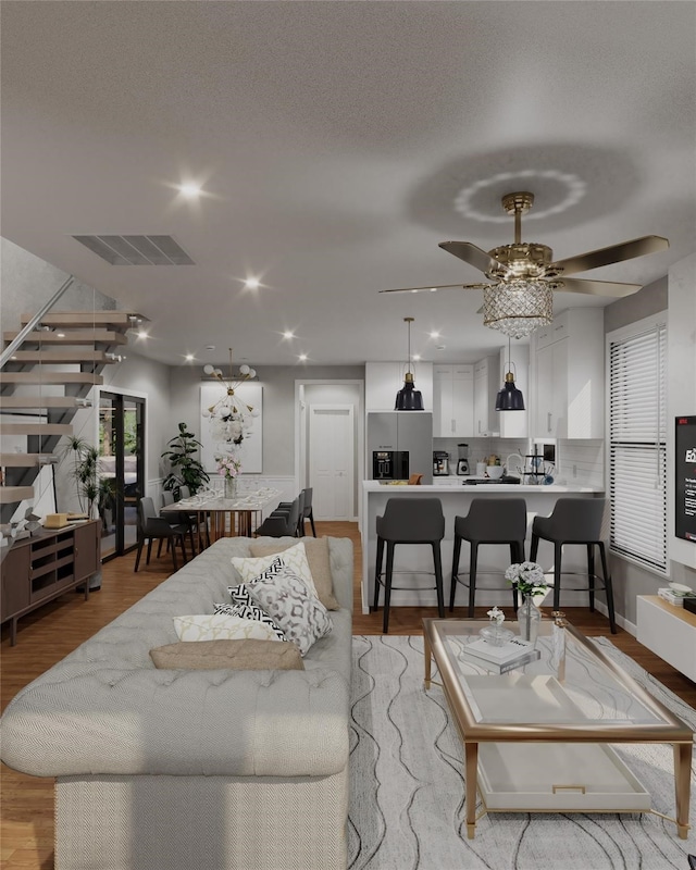 living room featuring ceiling fan and light wood-type flooring