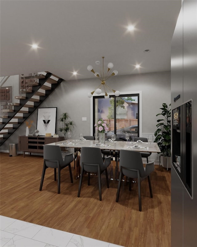 dining room featuring hardwood / wood-style flooring and a notable chandelier