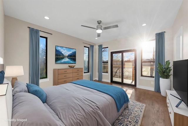 bedroom with wood-type flooring, multiple windows, ceiling fan, and access to outside