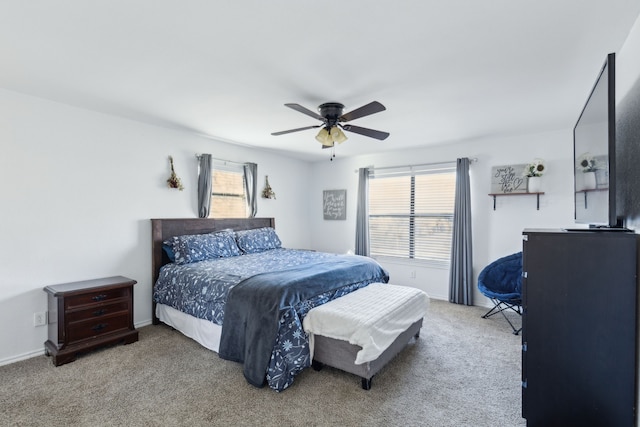 carpeted bedroom with ceiling fan and multiple windows