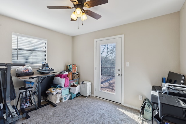 office space with ceiling fan and light carpet