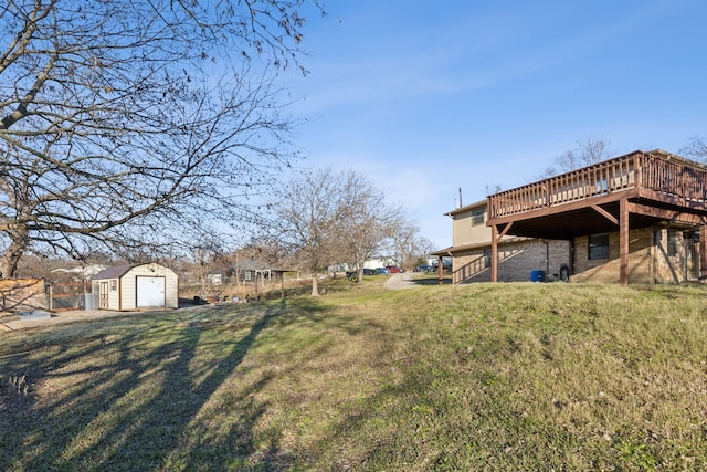 view of yard featuring a deck and a storage shed