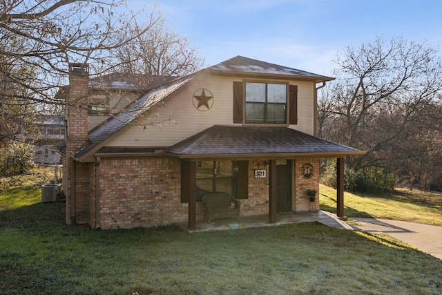 view of front of property featuring central air condition unit, a patio area, and a front lawn