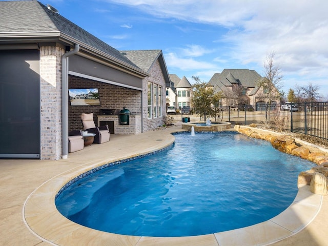 view of swimming pool with an in ground hot tub, a patio, and an outdoor kitchen