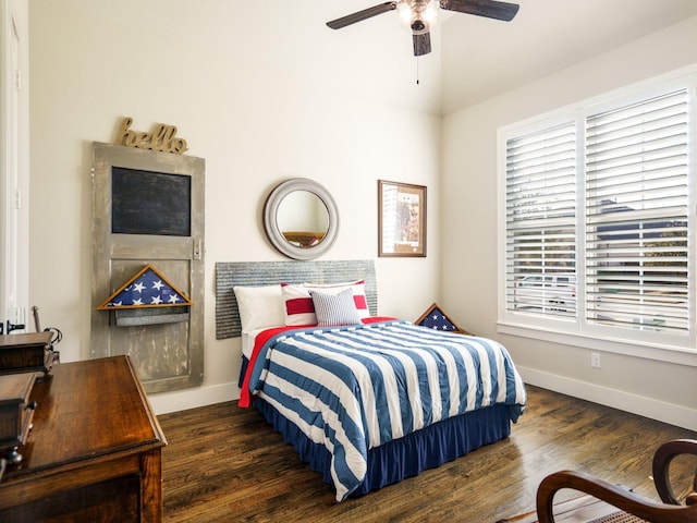 bedroom featuring multiple windows, dark hardwood / wood-style floors, and ceiling fan