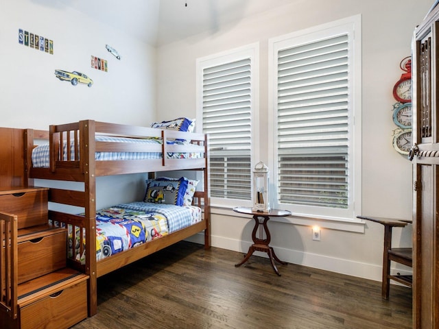 bedroom with dark hardwood / wood-style floors