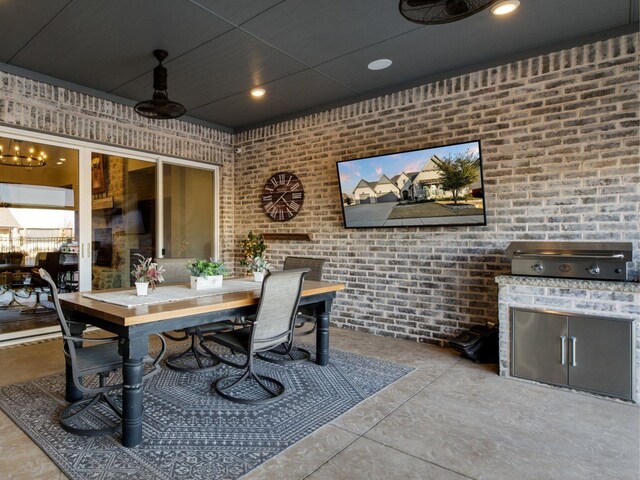 view of patio / terrace featuring ceiling fan and exterior kitchen