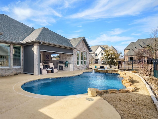 view of swimming pool featuring an in ground hot tub, an outdoor kitchen, and a patio area