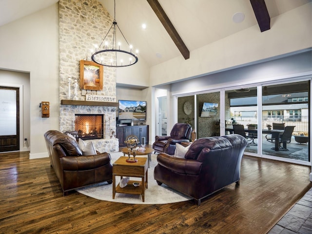 living room featuring a stone fireplace, dark wood-type flooring, an inviting chandelier, and high vaulted ceiling