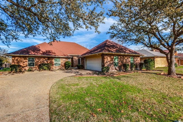 ranch-style house featuring a front yard and a garage