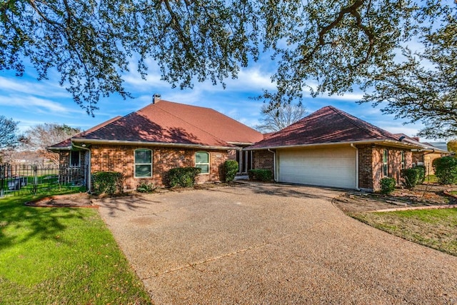 ranch-style home featuring a front lawn and a garage