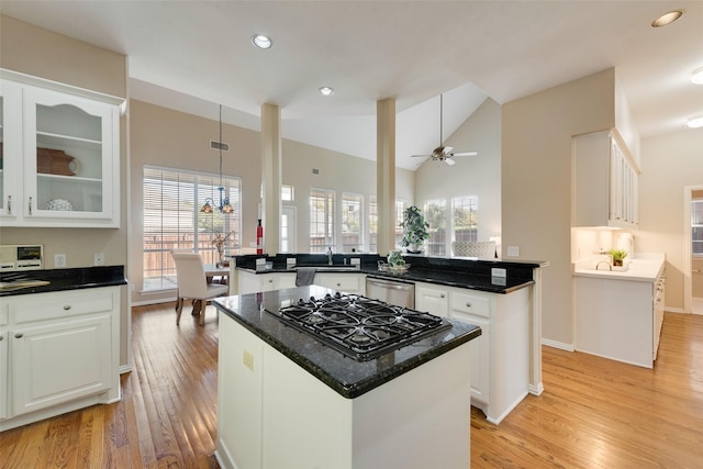 kitchen featuring a kitchen island, white cabinets, ceiling fan, and kitchen peninsula