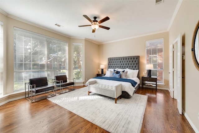 bedroom featuring ceiling fan, crown molding, and dark hardwood / wood-style floors