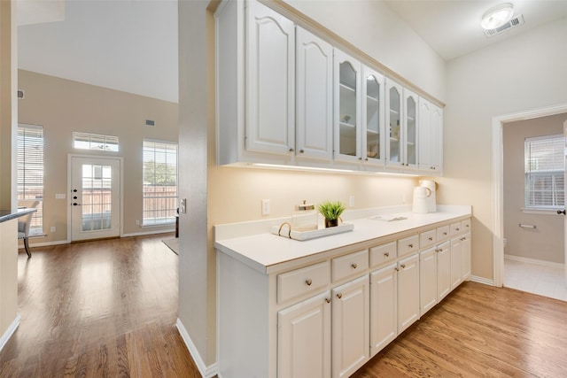 kitchen featuring white cabinets and light hardwood / wood-style floors