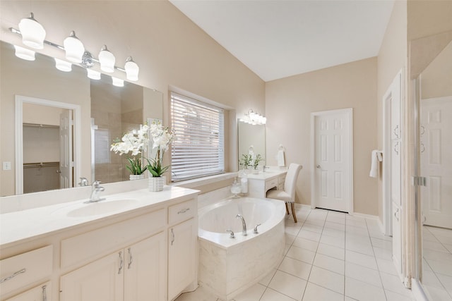 bathroom featuring lofted ceiling, tile patterned flooring, a relaxing tiled tub, and vanity