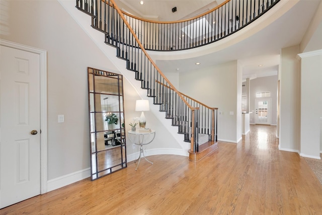 foyer with a high ceiling and light hardwood / wood-style flooring