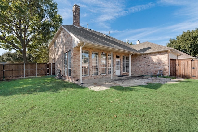 rear view of house featuring a patio area and a yard