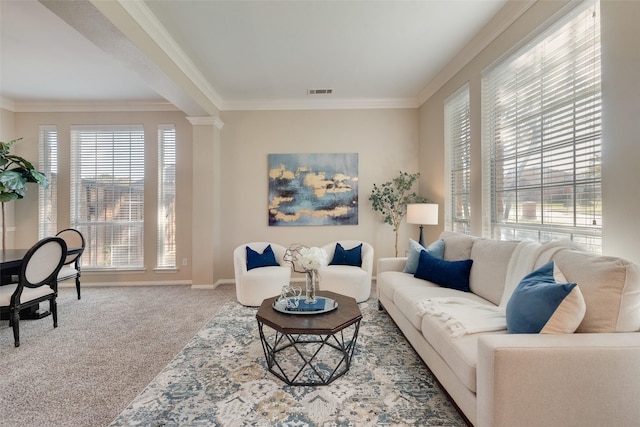 carpeted living room featuring ornamental molding and plenty of natural light