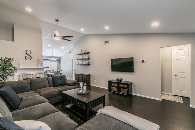 living room with dark hardwood / wood-style flooring, a tile fireplace, ceiling fan, and vaulted ceiling