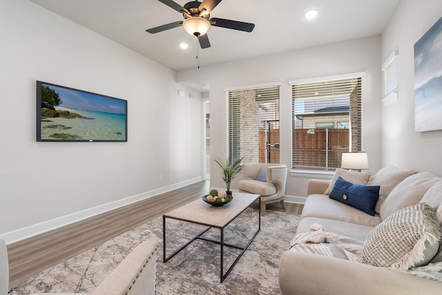 living room featuring ceiling fan and light hardwood / wood-style floors