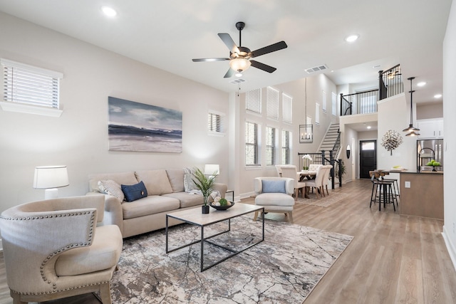 living room with hardwood / wood-style flooring and ceiling fan