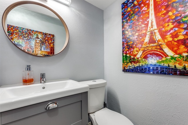 bathroom with toilet and vanity