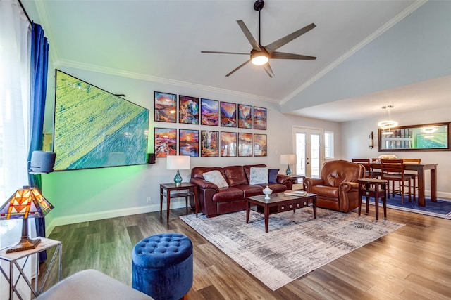 living room with hardwood / wood-style flooring, french doors, high vaulted ceiling, ornamental molding, and ceiling fan