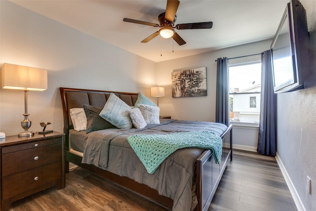 bedroom with ceiling fan and dark hardwood / wood-style flooring