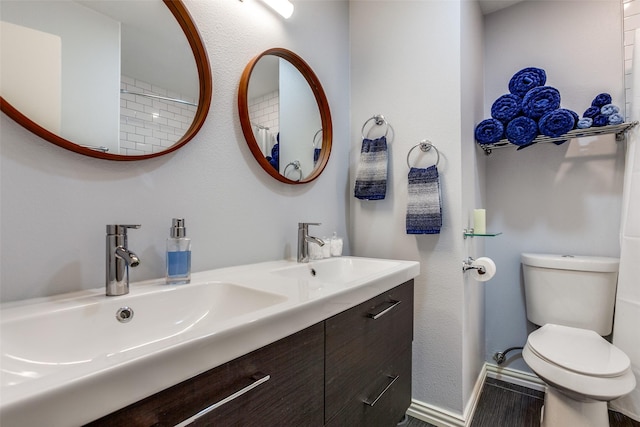 bathroom featuring toilet and vanity