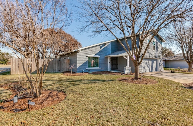 view of front of property with a front yard and a garage