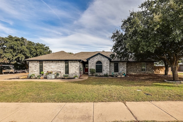 french provincial home featuring a front lawn