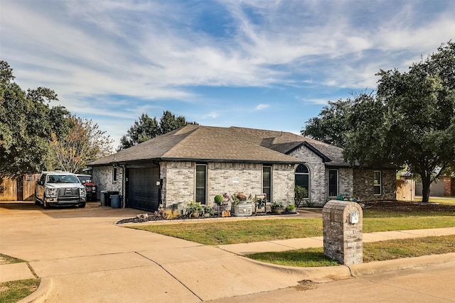 view of front of house featuring a garage and a front yard