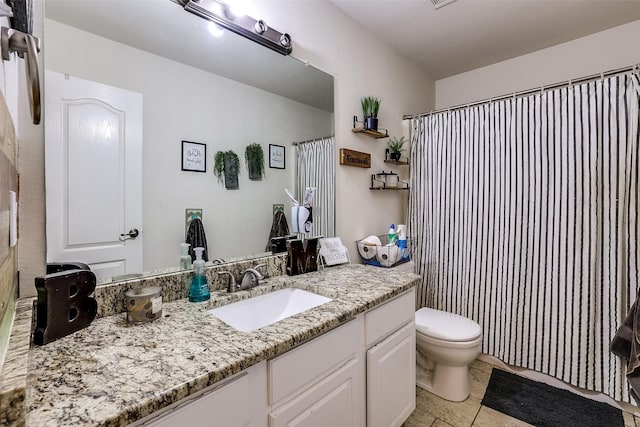 bathroom with toilet, tile patterned flooring, walk in shower, and vanity