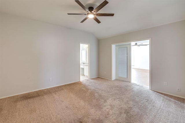 spare room with lofted ceiling, ceiling fan, and light colored carpet